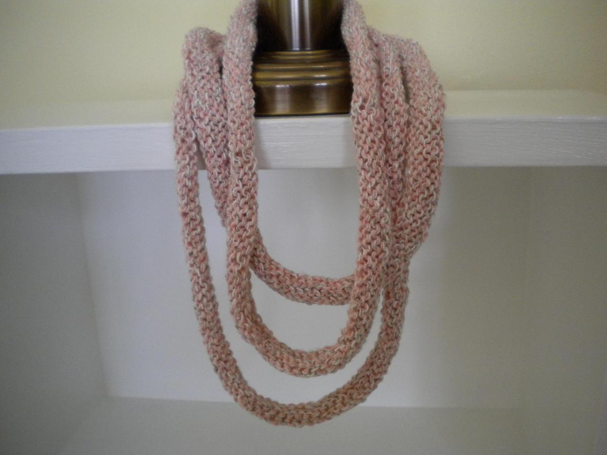 3 Strand Hand Knit Necklace Of Salmon Pink And Ivory Colored Yarns.